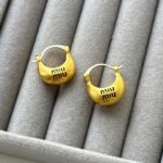 сережки miu miu у золоті