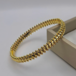 Жорсткий браслет Cartier Clash з рухливими елементами лимонне золото