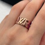 Широка каблучка Louis Vuitton з прорізами та логотипом рожеве золото на руці