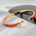 Вишуканий жорсткий браслет Hermes з логотипом у золоті помаранчевий лого